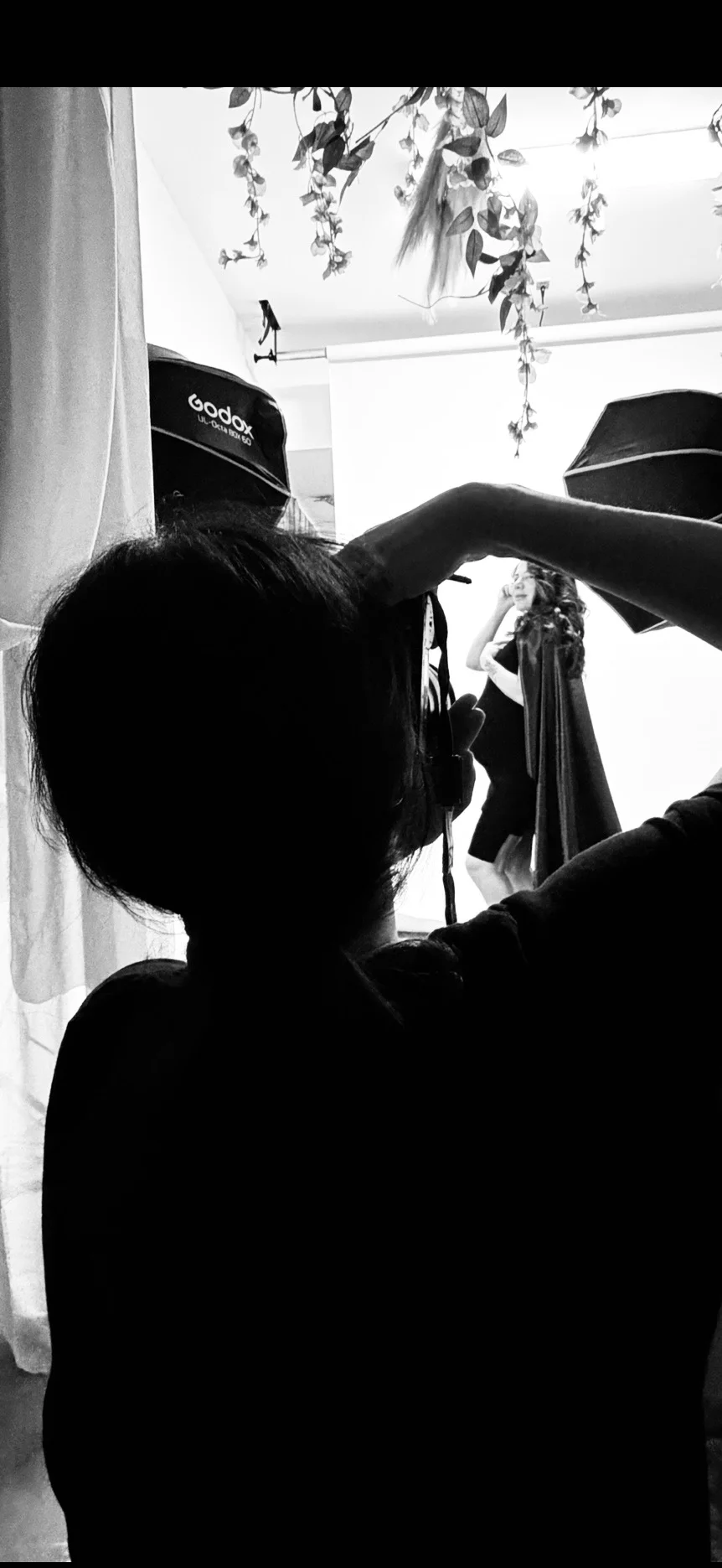 Photographer working beside a bright studio window