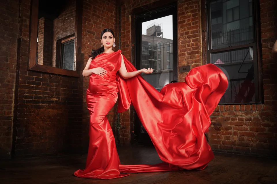Portrait with a red gown and lifted flowing fabric