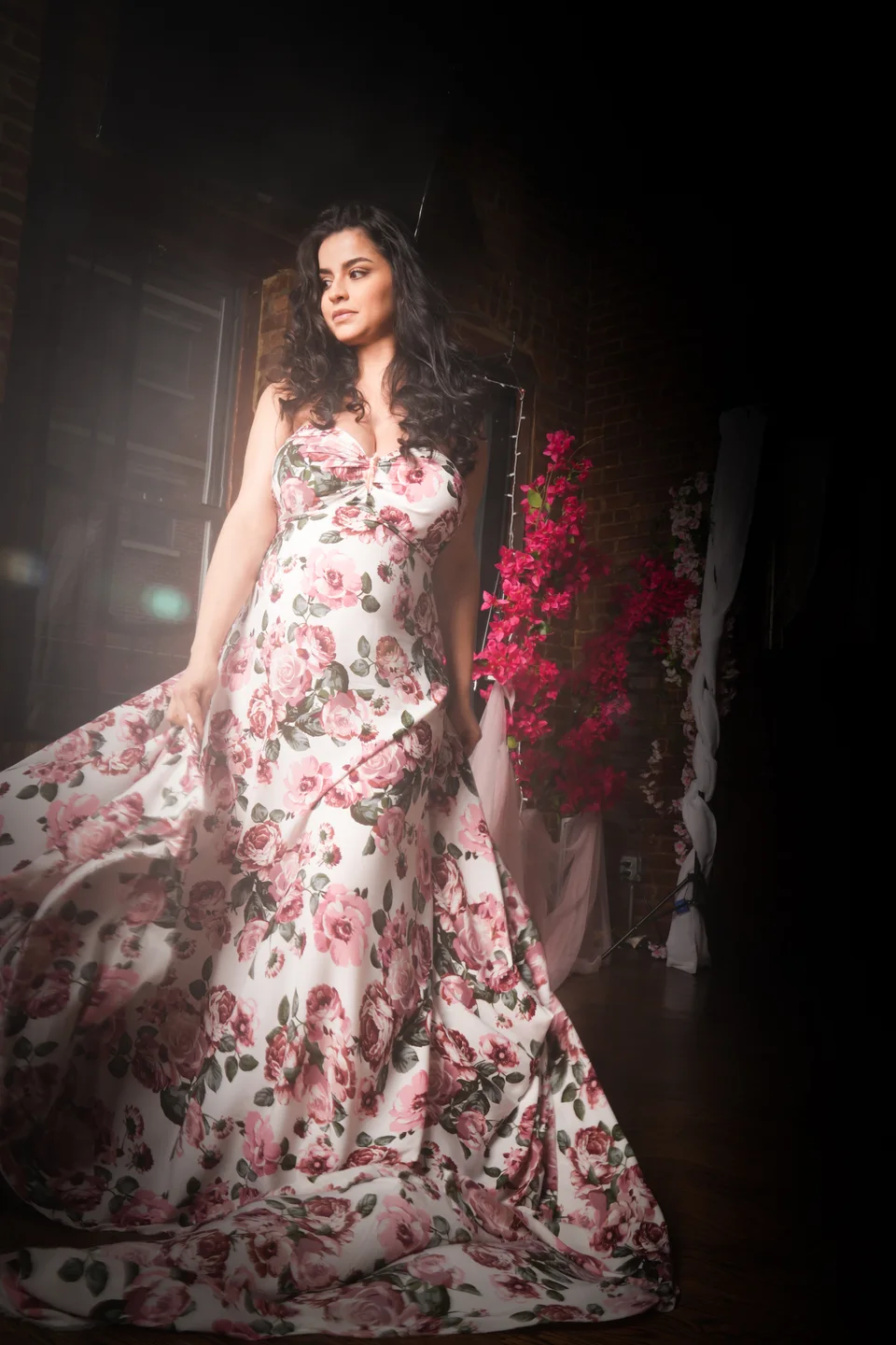Maternity portrait with a floral dress and dramatic light