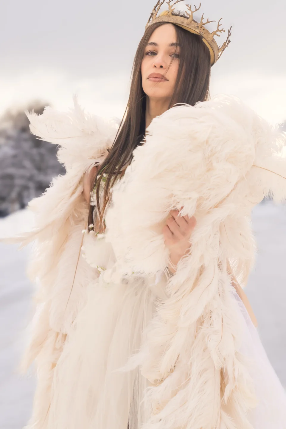 Portrait with a crown and cream feather wrap