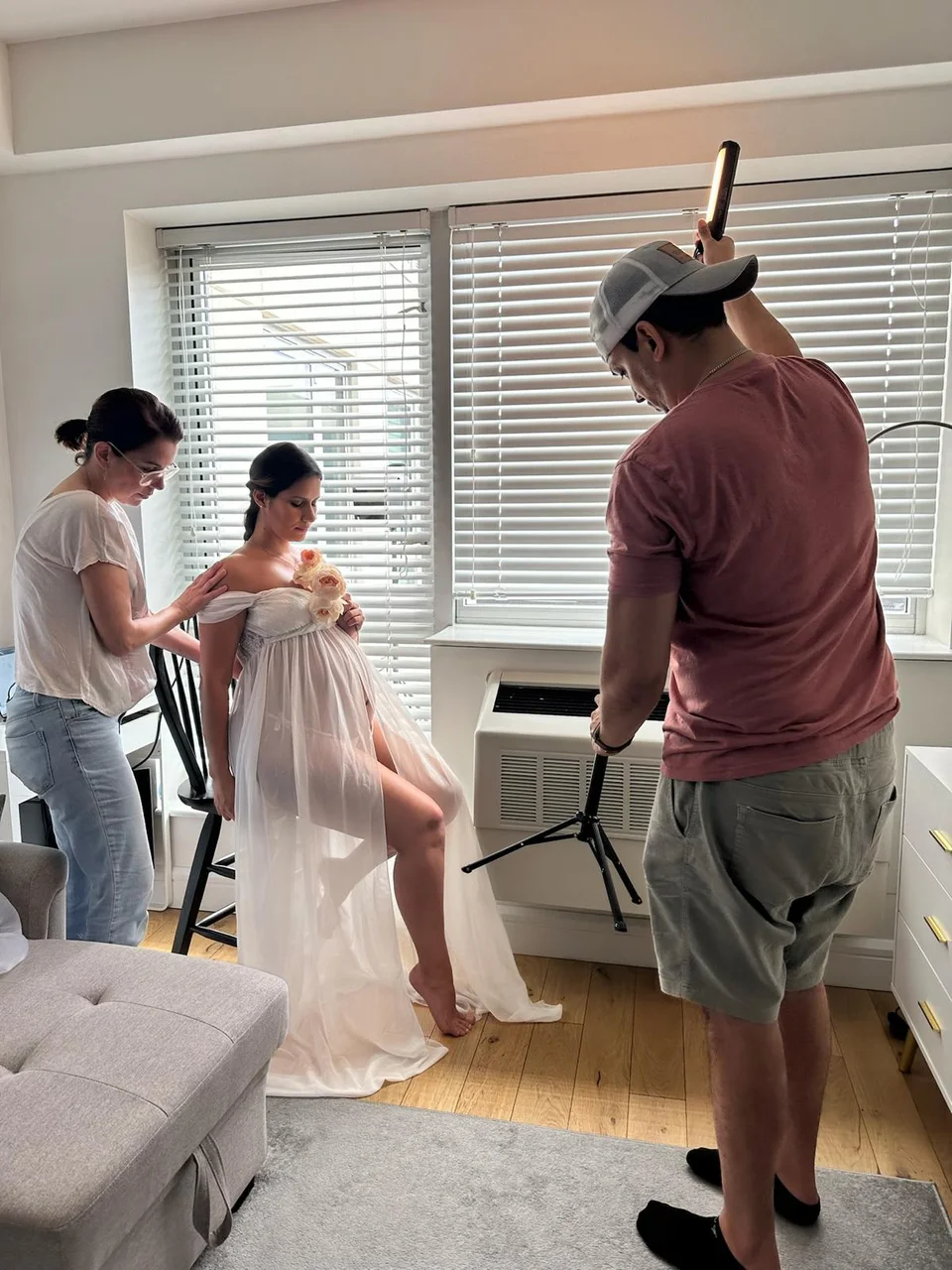 Photography team preparing a portrait in a living room