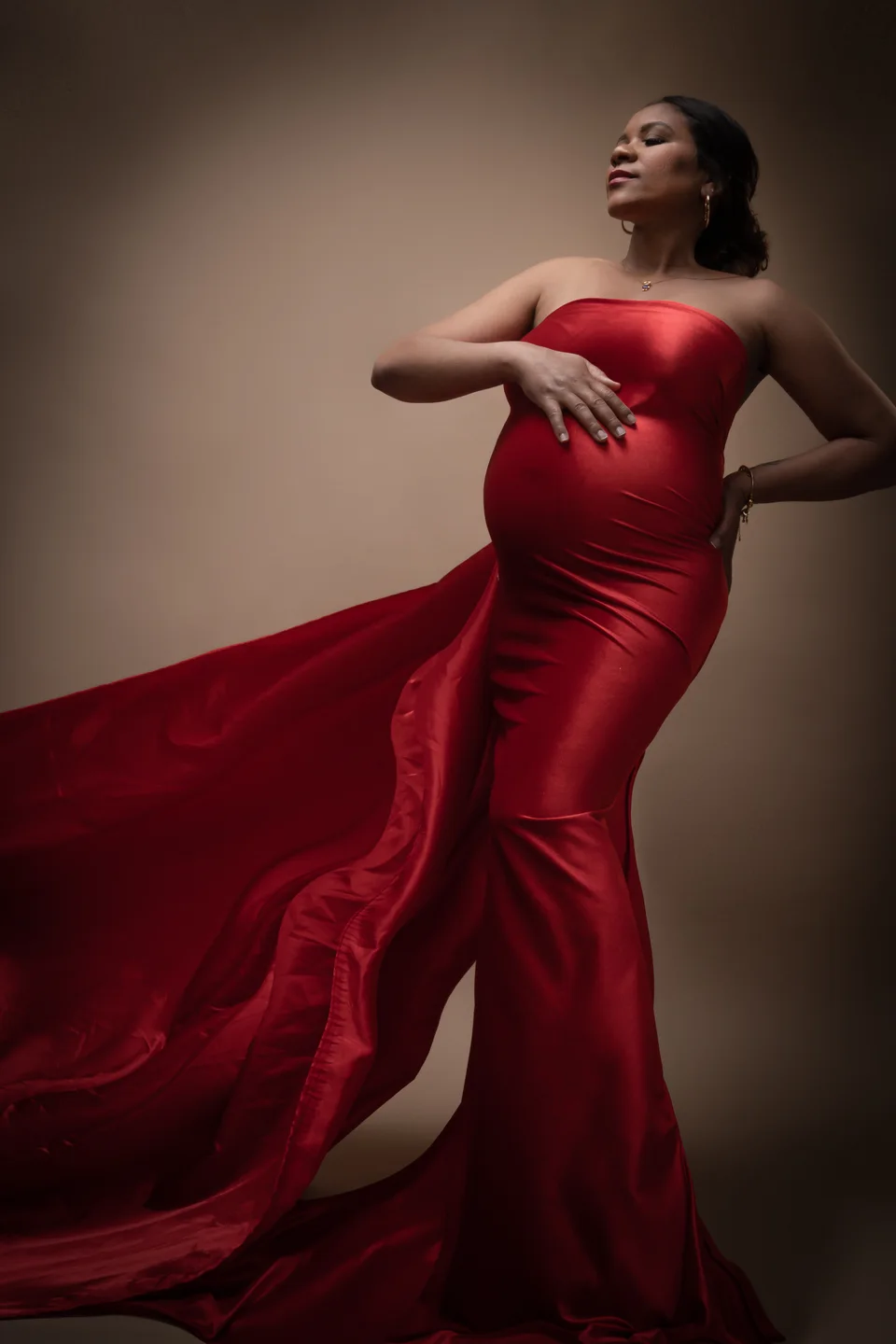 Maternity portrait with a flowing red gown