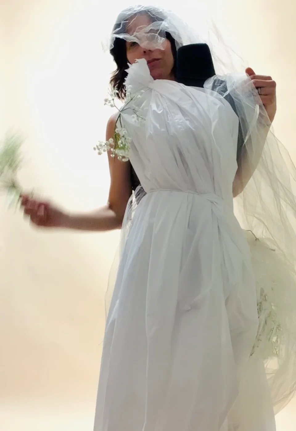 White dress being adjusted on a mannequin